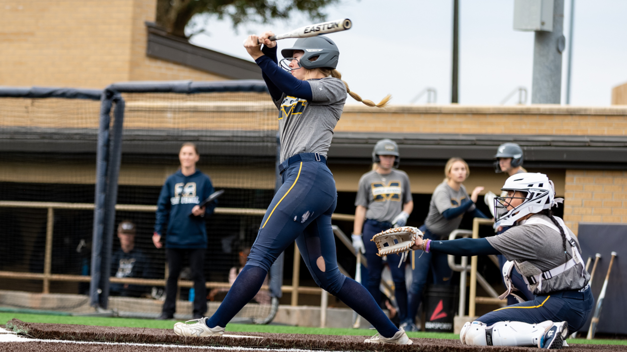 Softball splits on opening day